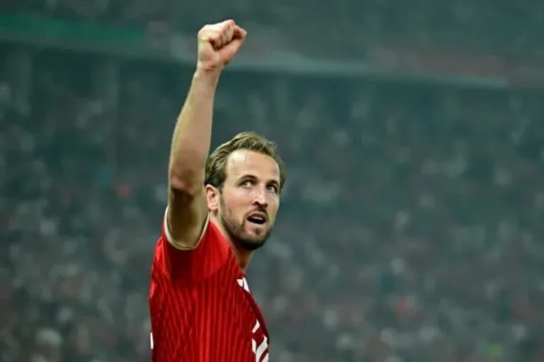 Player celebrating with raised fist in stadium Player celebrating with raised fist in stadium