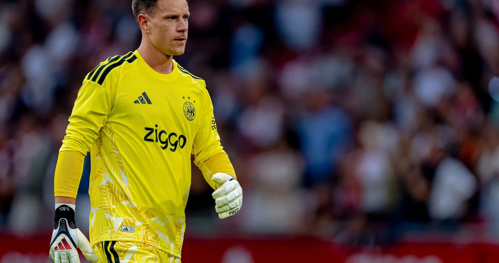 Goalkeeper in yellow kit walking on the field Goalkeeper in yellow kit walking on the field