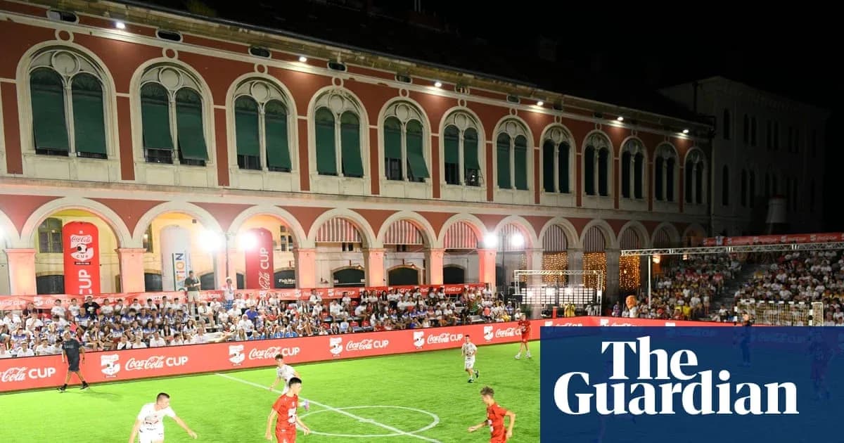Players competing in a night football match outdoors Players competing in a night football match outdoors