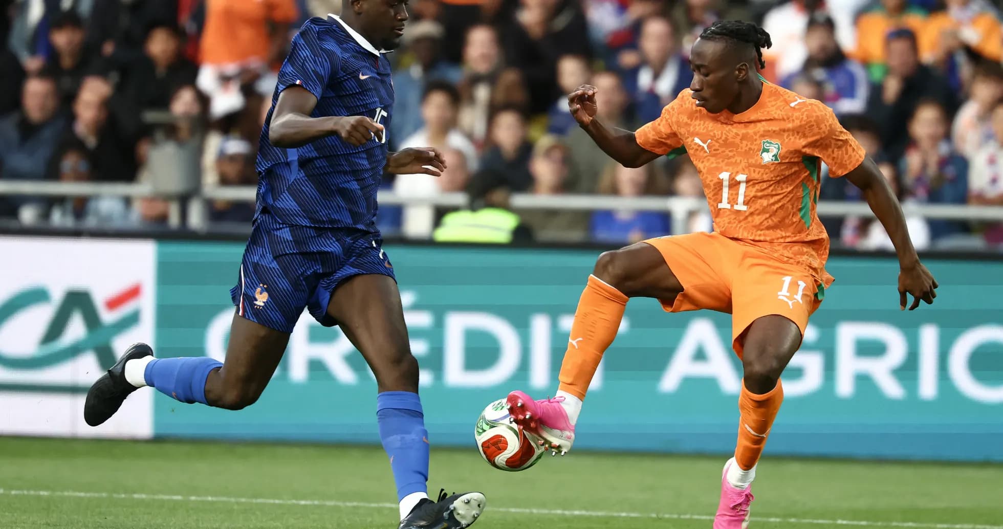 Player dribbling past opponent during football match Player dribbling past opponent during football match