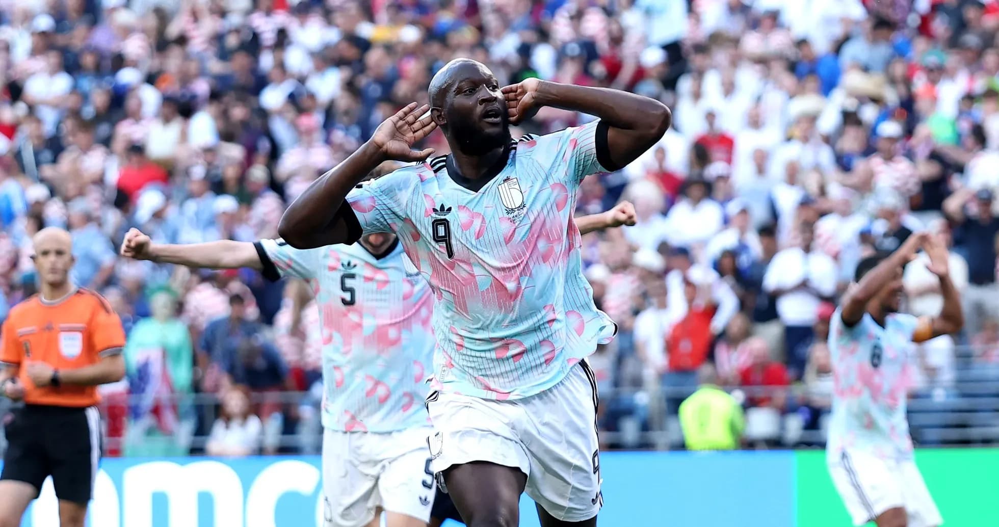 Player celebrating goal with fans during match Player celebrating goal with fans during match