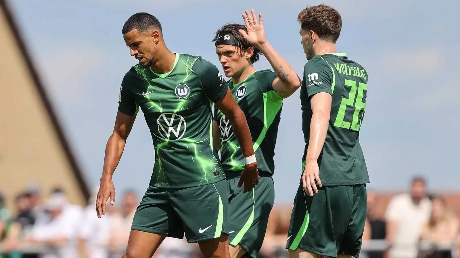 Wolfsburg players interacting on the field during match Wolfsburg players interacting on the field during match