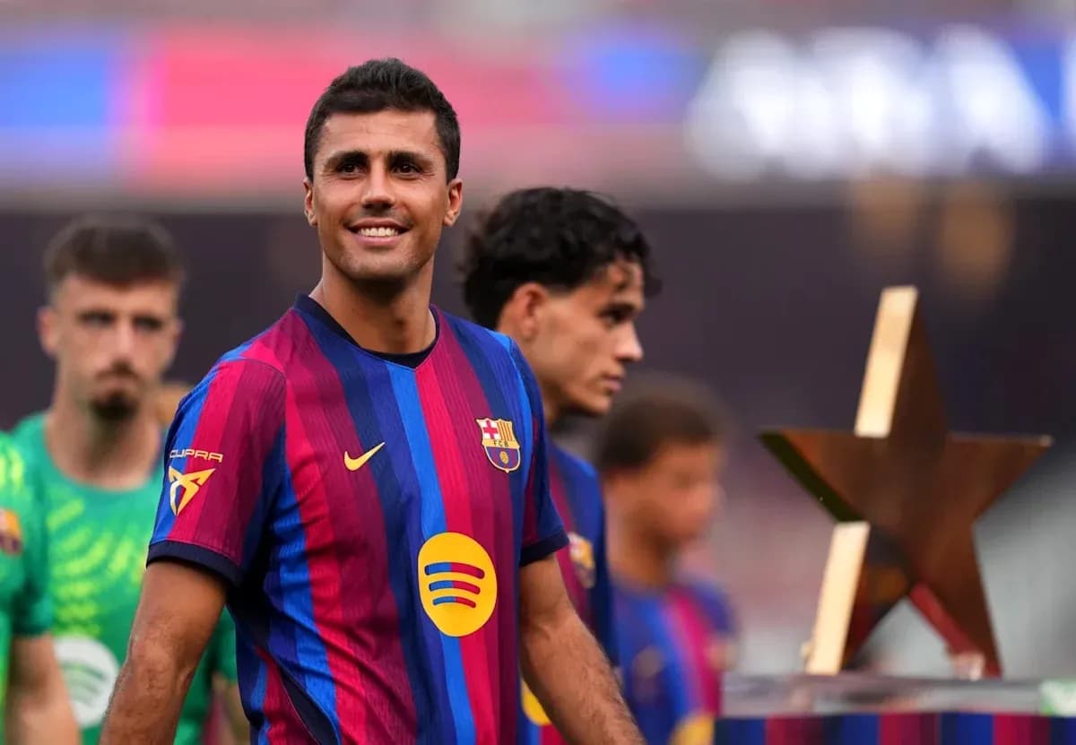 Barcelona player smiling with teammates and trophy Barcelona player smiling with teammates and trophy