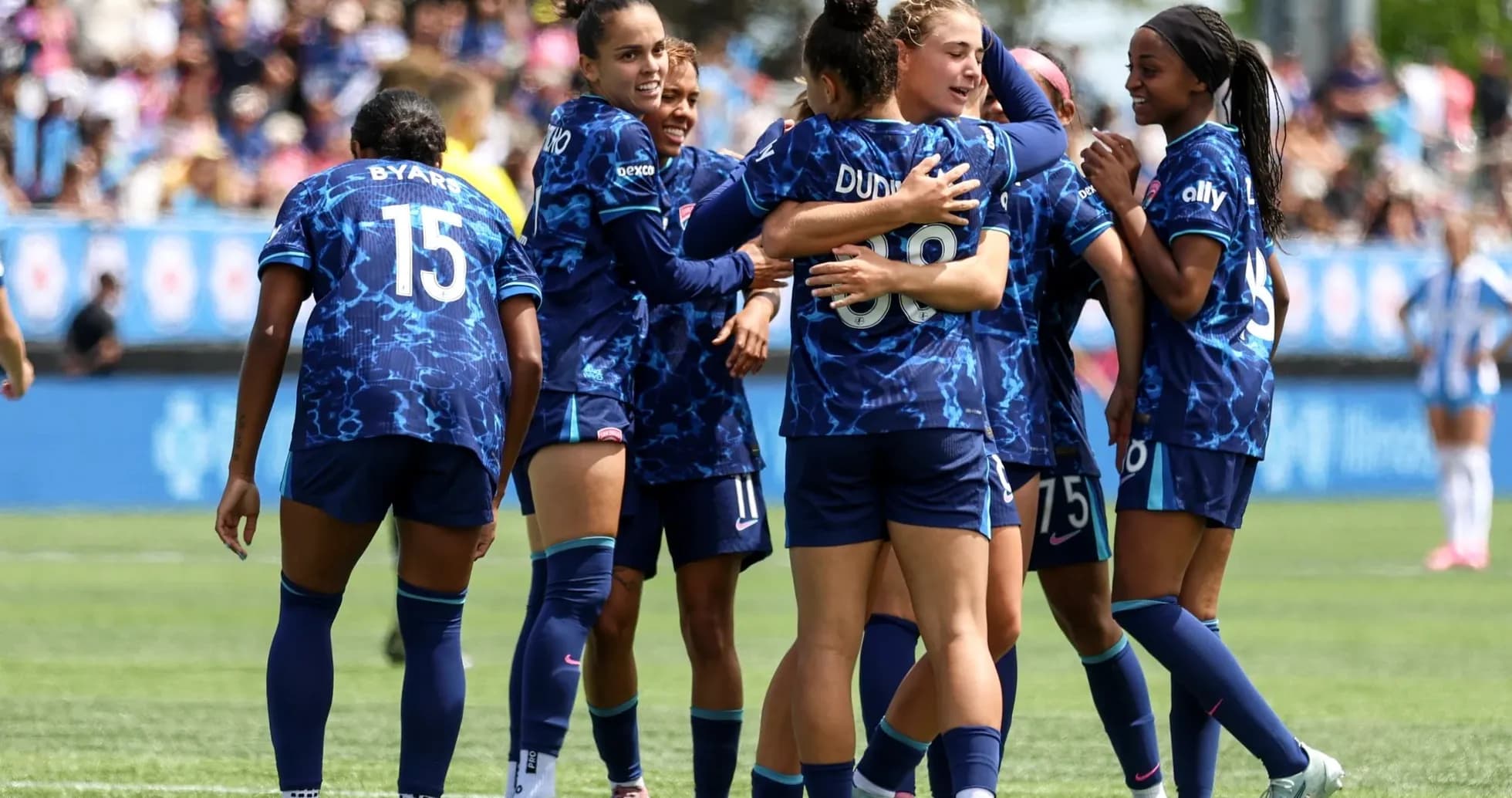 Seattle Reign FC players celebrating a goal Seattle Reign FC players celebrating a goal