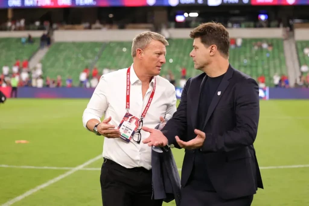 Two coaches discussing on the field post-match Two coaches discussing on the field post-match