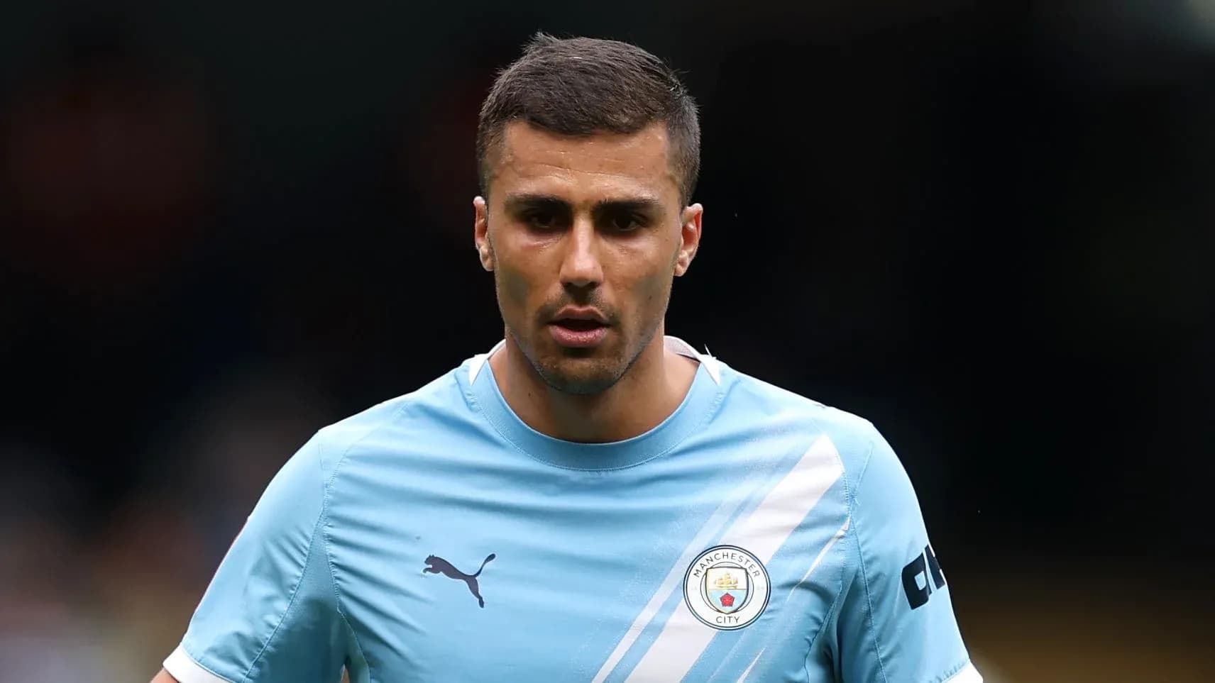 Player in Manchester City kit walking on pitch Player in Manchester City kit walking on pitch