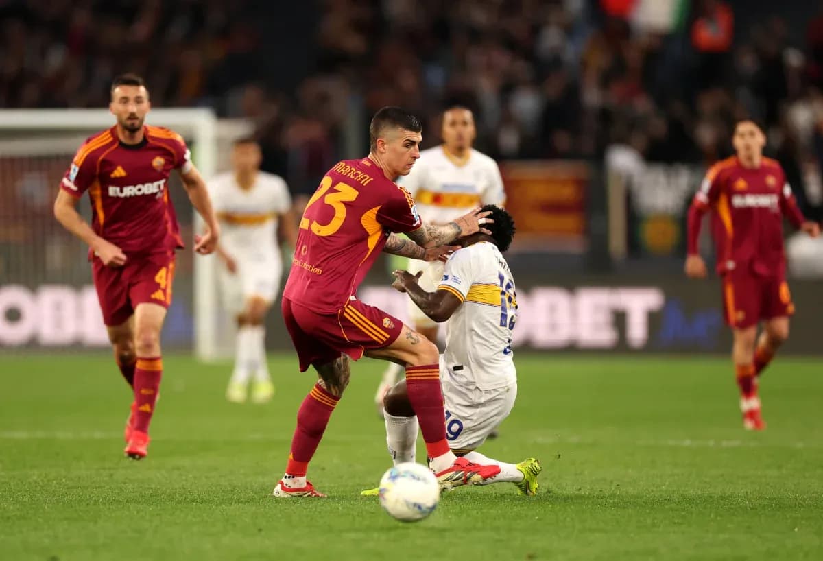 AS Roma player challenges Lecce opponent during match AS Roma player challenges Lecce opponent during match