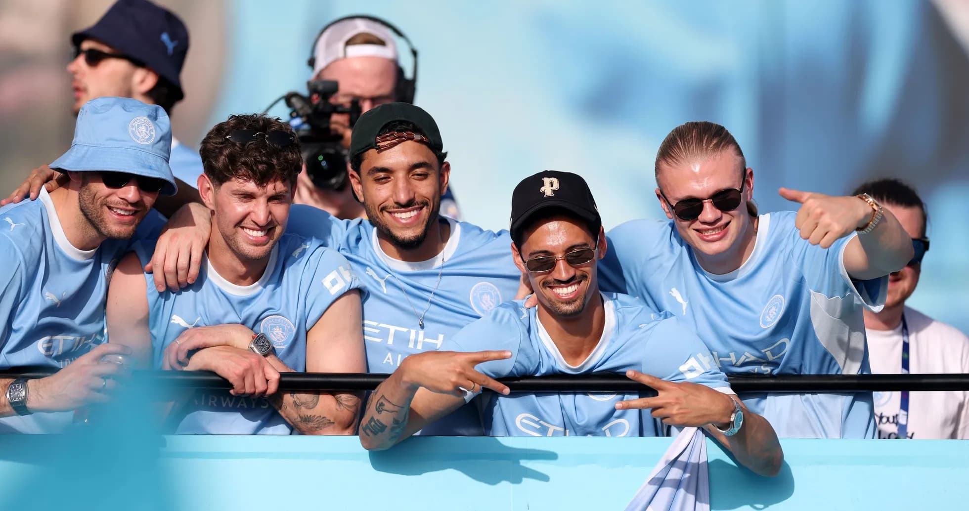 Group of fans celebrating in Manchester City jerseys Group of fans celebrating in Manchester City jerseys