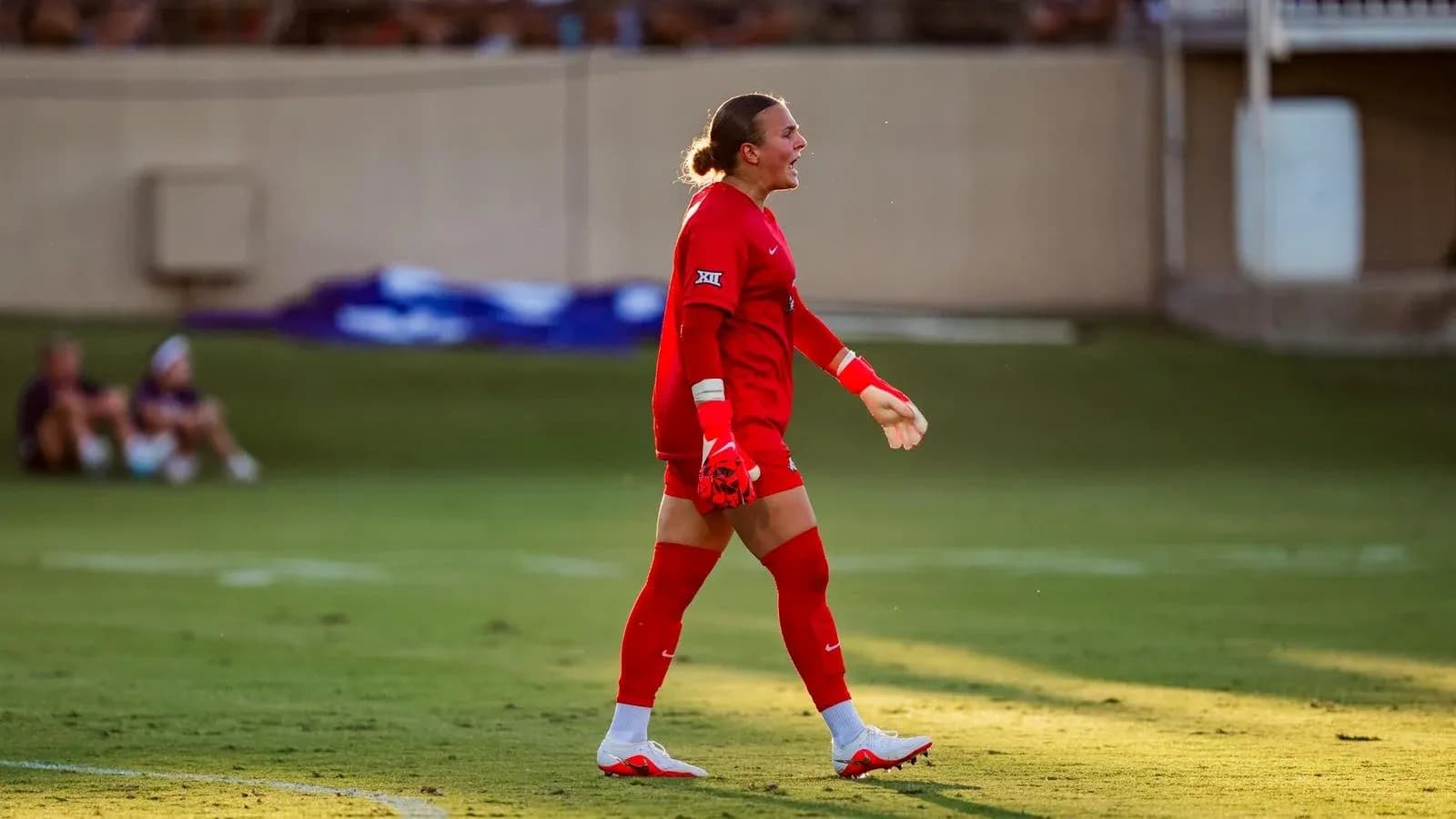 Goalkeeper in red uniform during soccer match Goalkeeper in red uniform during soccer match