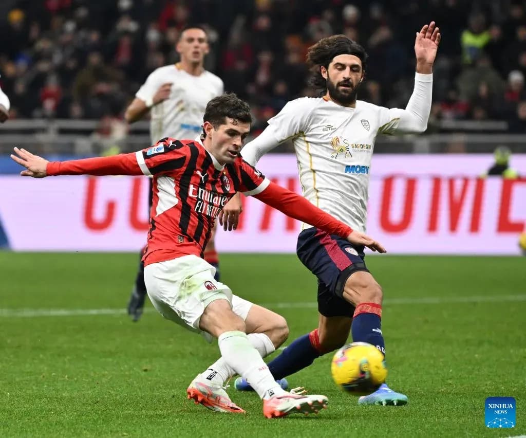 AC Milan player challenges Cagliari opponent during match AC Milan player challenges Cagliari opponent during match