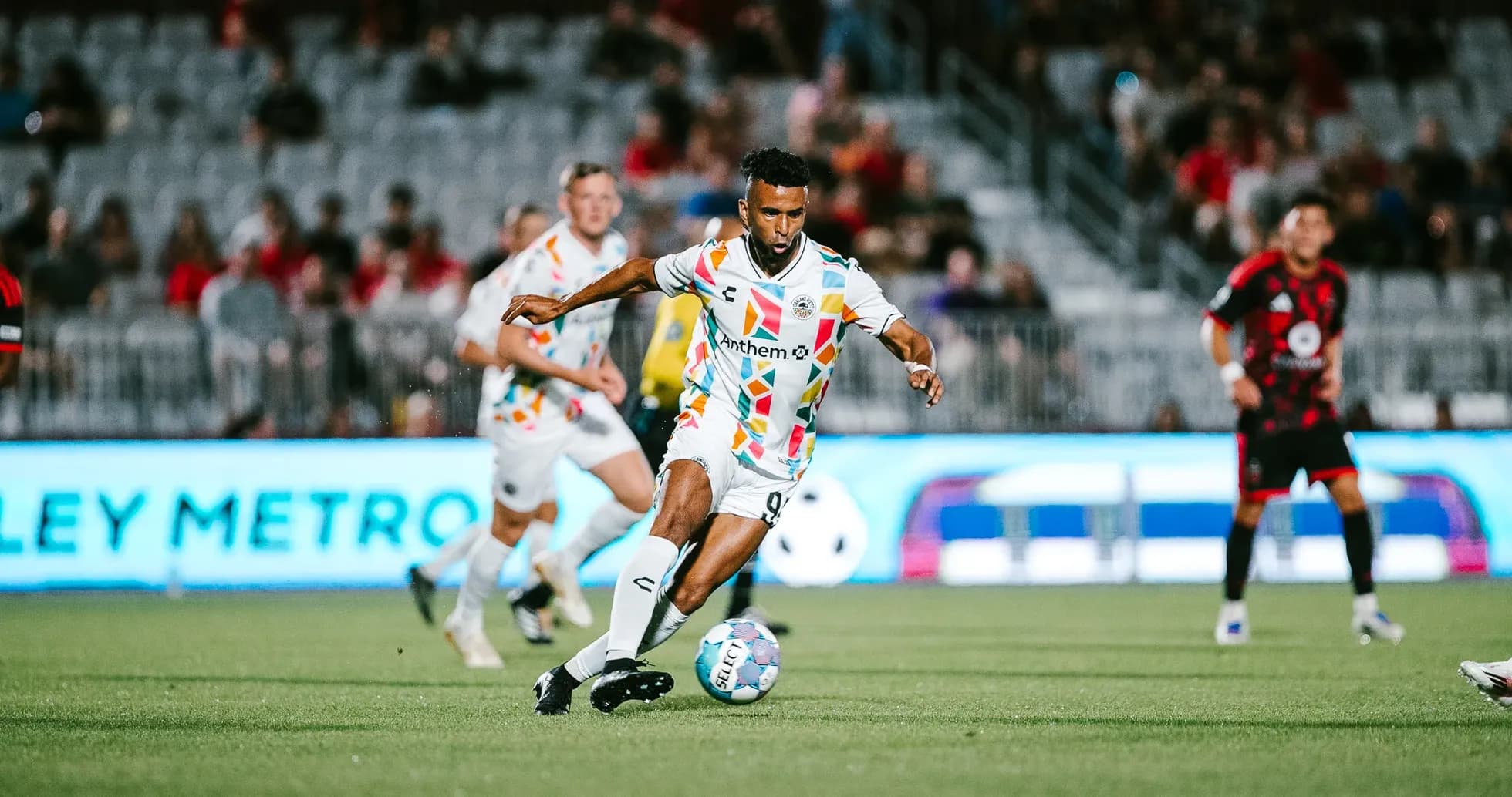 Player dribbling the ball during football match Player dribbling the ball during football match
