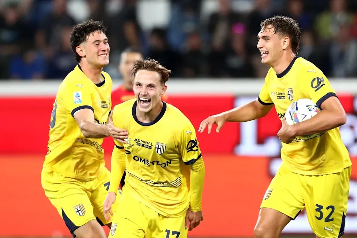 Three Parma players celebrating a goal together Three Parma players celebrating a goal together
