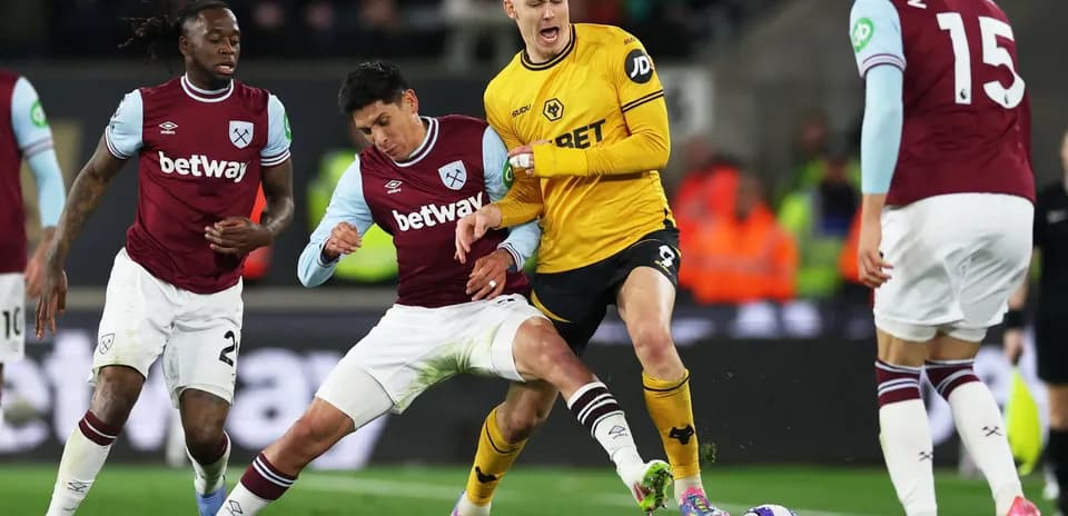 West Ham players challenging Wolves attacker during match West Ham players challenging Wolves attacker during match