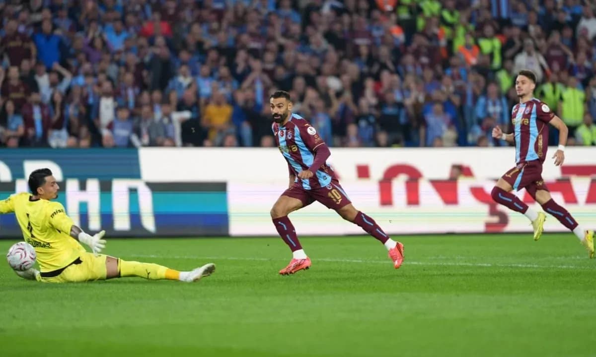 Player celebrating after scoring against the goalkeeper Player celebrating after scoring against the goalkeeper