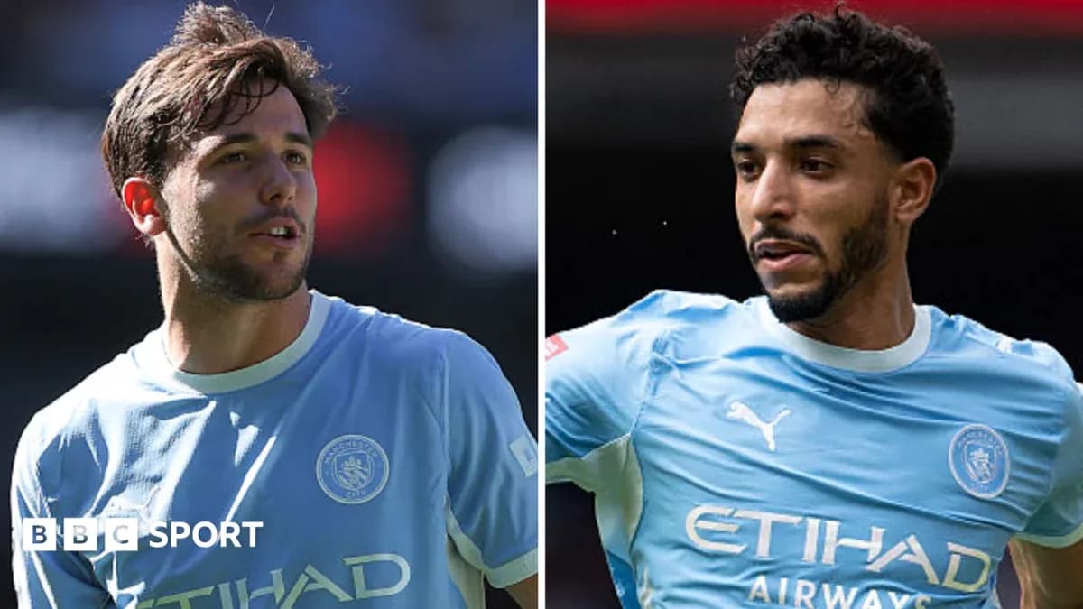 Two Manchester City players in light blue jerseys Two Manchester City players in light blue jerseys