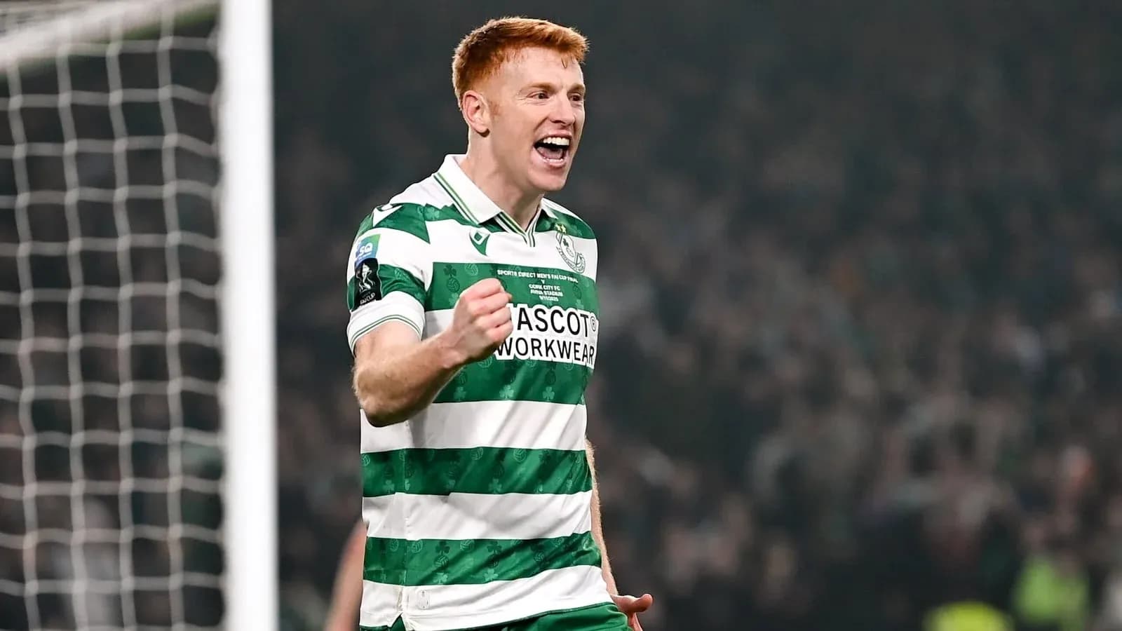Player celebrating a goal in green and white jersey Player celebrating a goal in green and white jersey