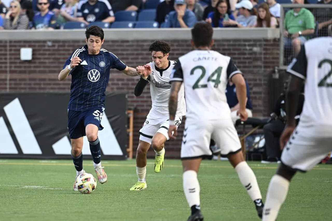 Chattanooga player dribbling against Carolina defender Chattanooga player dribbling against Carolina defender
