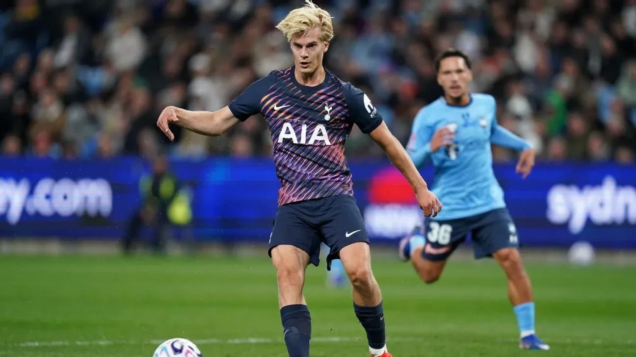 Tottenham player dribbling the ball during match Tottenham player dribbling the ball during match