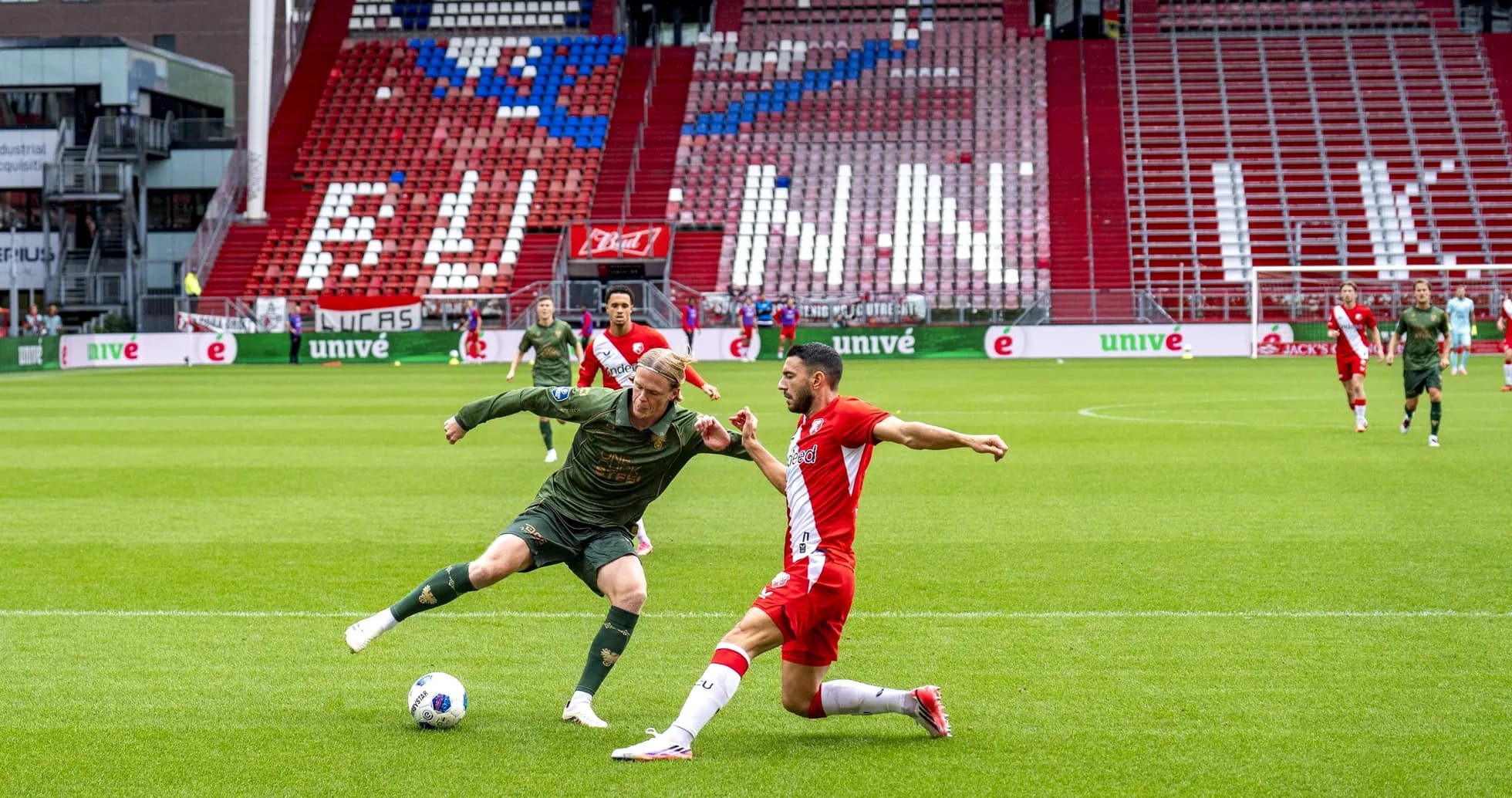 Two players contesting the ball during a match Two players contesting the ball during a match