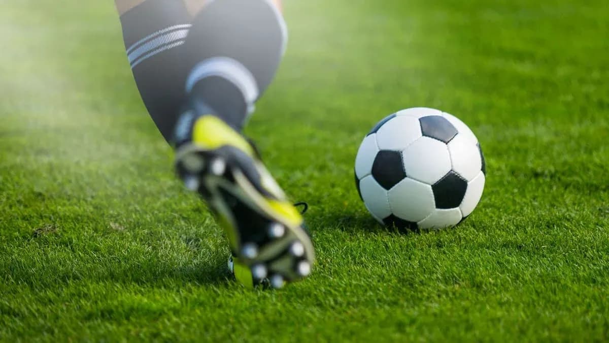 Player kicking a soccer ball on the field Player kicking a soccer ball on the field