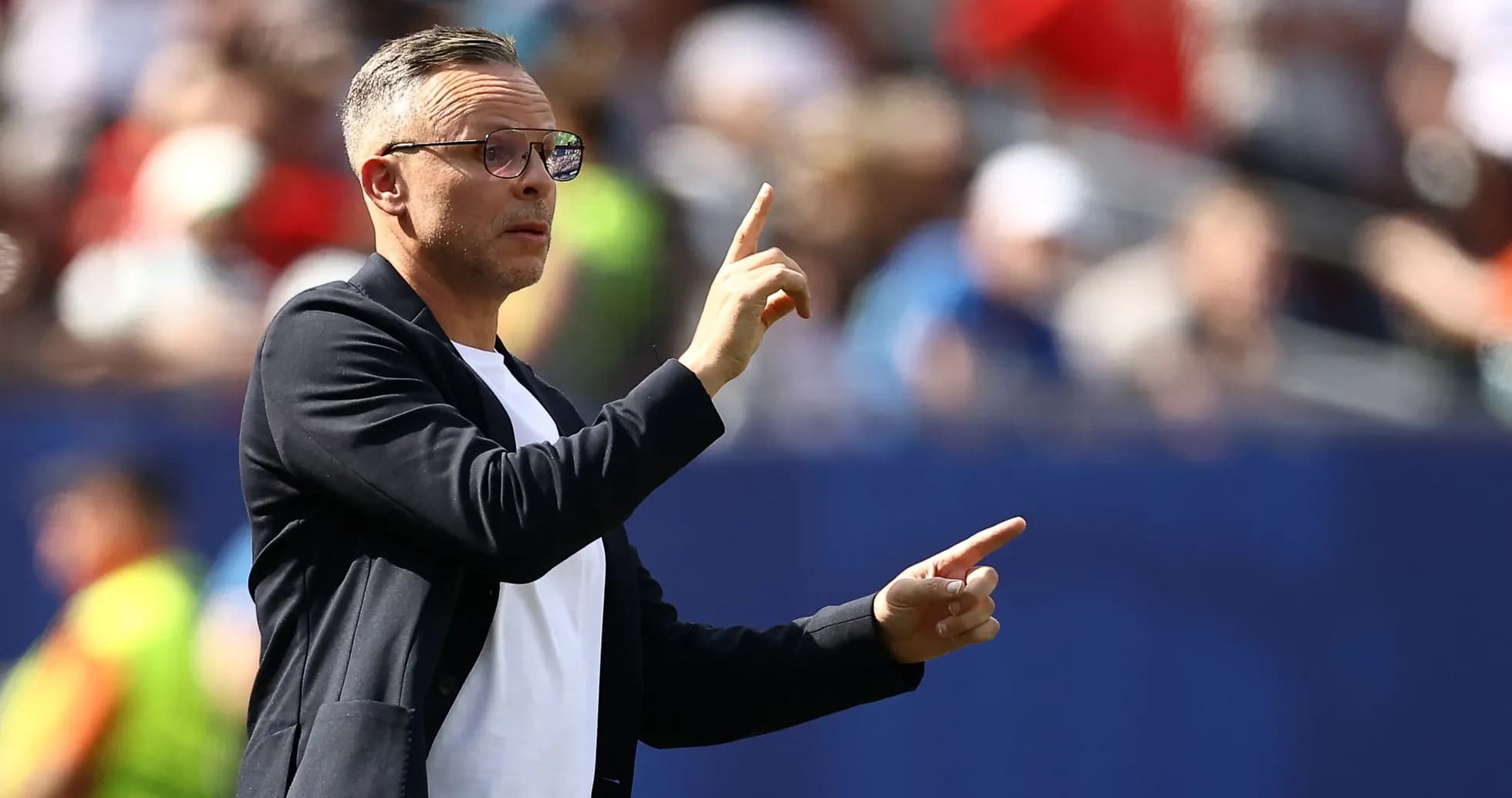 Coach gesturing during a match from the sideline Coach gesturing during a match from the sideline