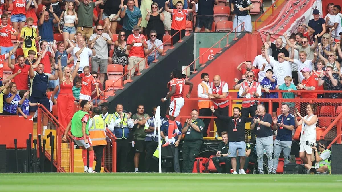 Players celebrating with enthusiastic fans in stadium Players celebrating with enthusiastic fans in stadium