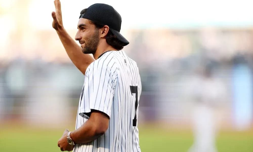 Person waving while wearing a baseball jersey Person waving while wearing a baseball jersey