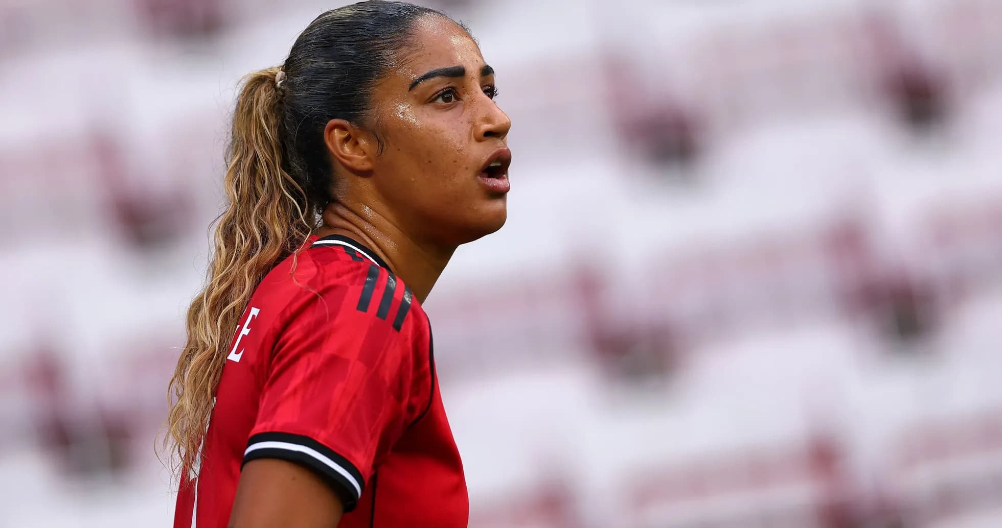 Player wearing red jersey during a match Player wearing red jersey during a match