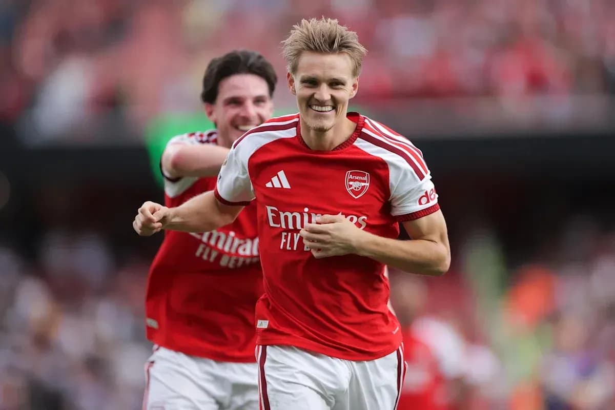 Arsenal players celebrating a goal on the field Arsenal players celebrating a goal on the field