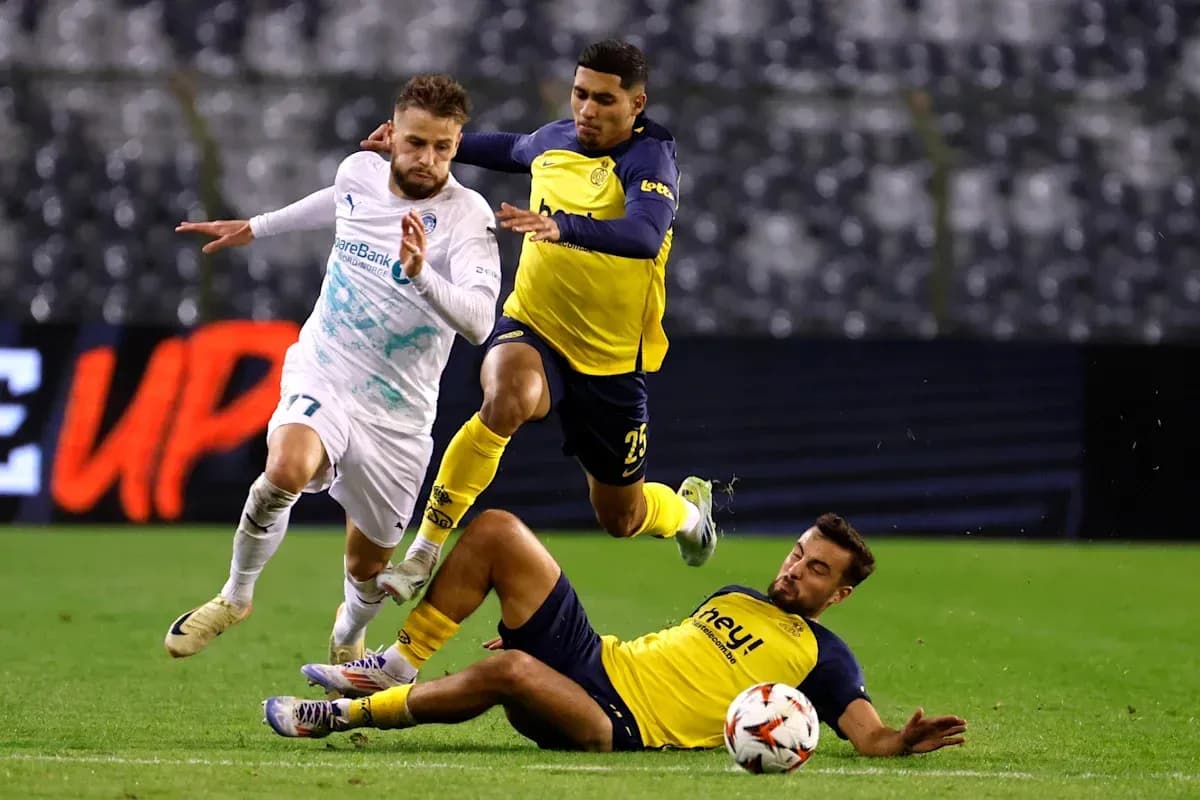 Player dribbling past defenders during football match Player dribbling past defenders during football match