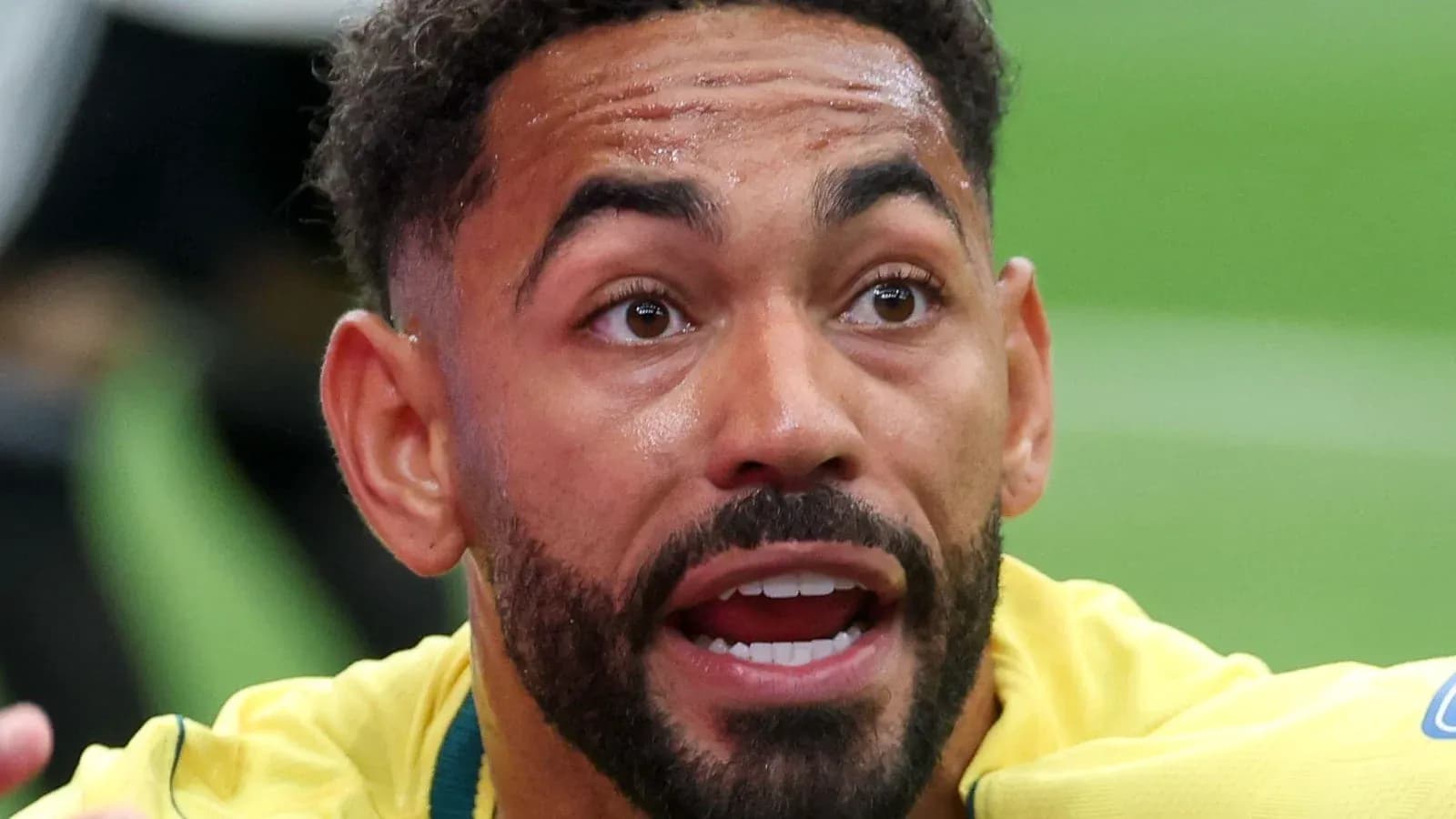 Player in yellow jersey expressing intensity during match Player in yellow jersey expressing intensity during match