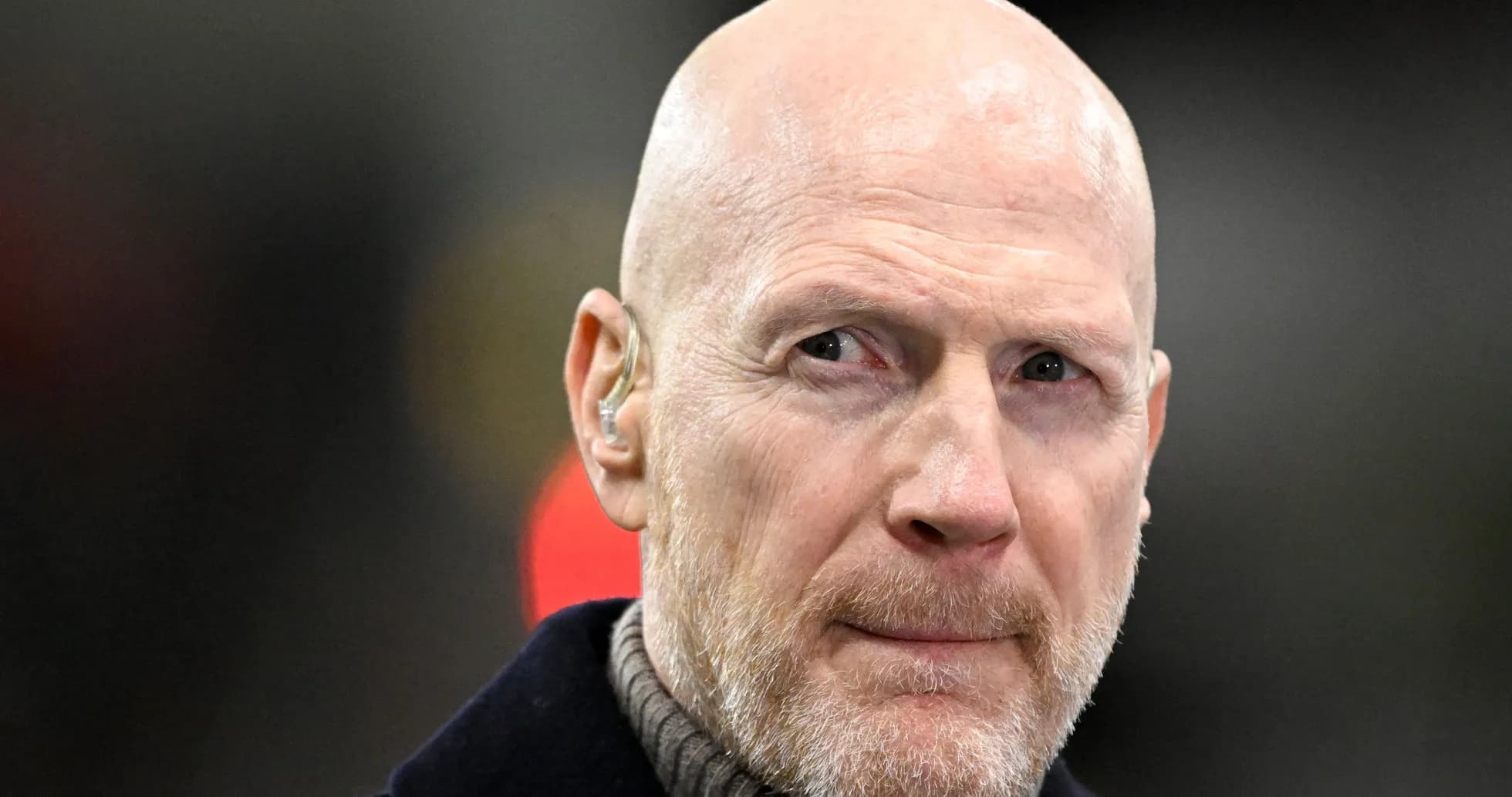 Bald man with earpiece looking thoughtfully Bald man with earpiece looking thoughtfully