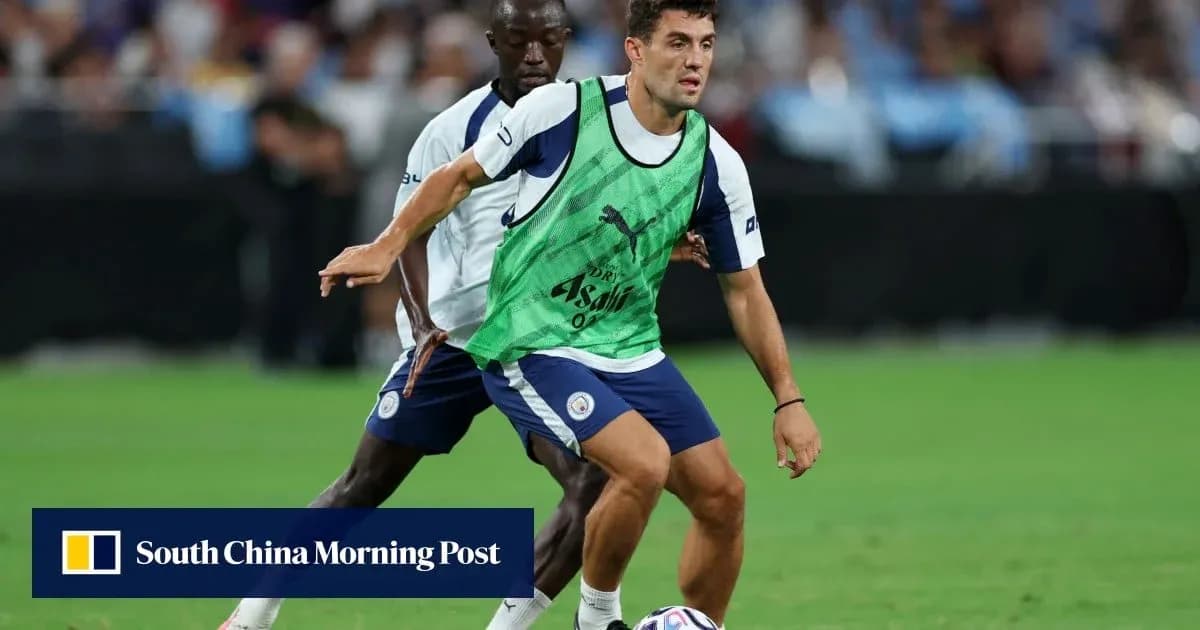 Two players training with a football on the pitch Two players training with a football on the pitch