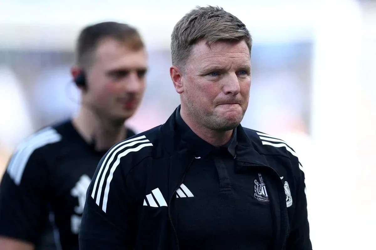 Manager walking off pitch with staff member Manager walking off pitch with staff member