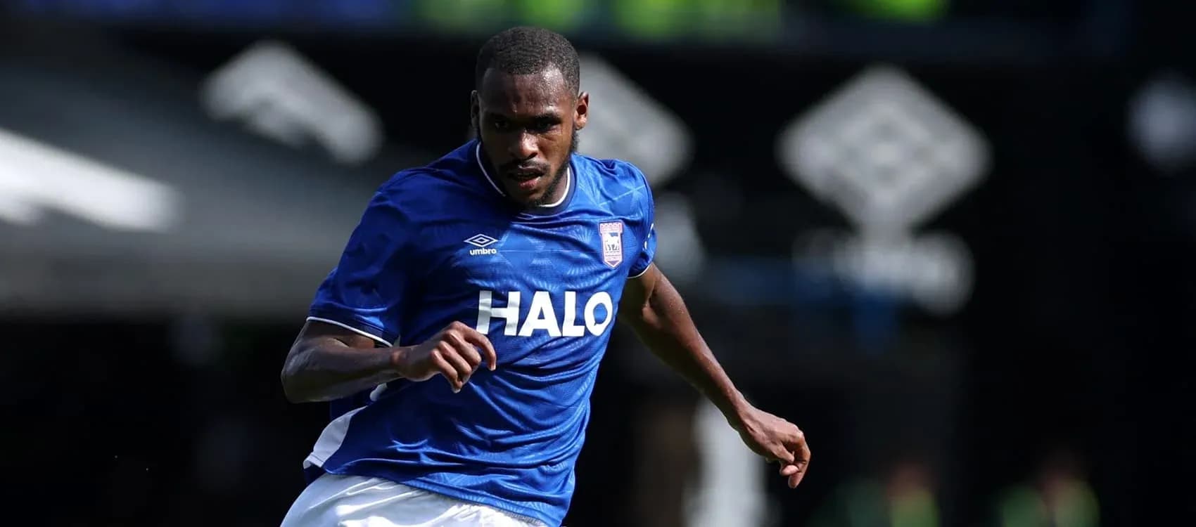 Player running in blue kit during match Player running in blue kit during match