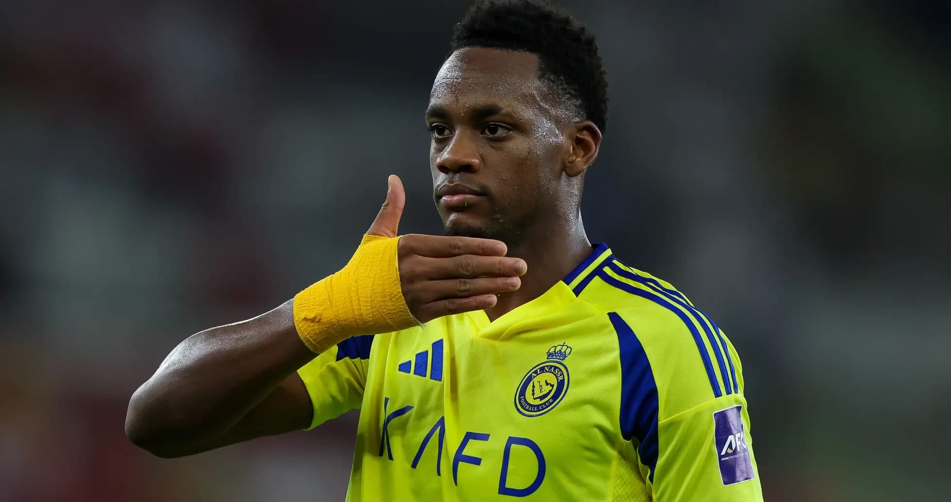 Player gesturing during a football match Player gesturing during a football match