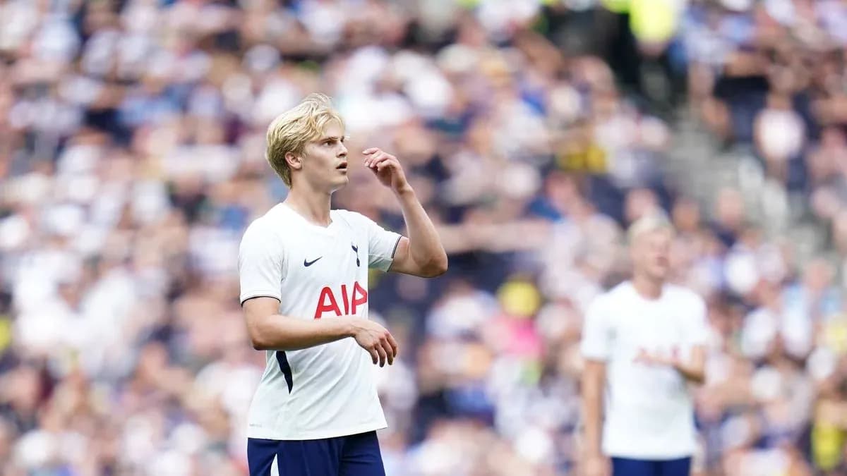 Tottenham player during match with fans in background Tottenham player during match with fans in background