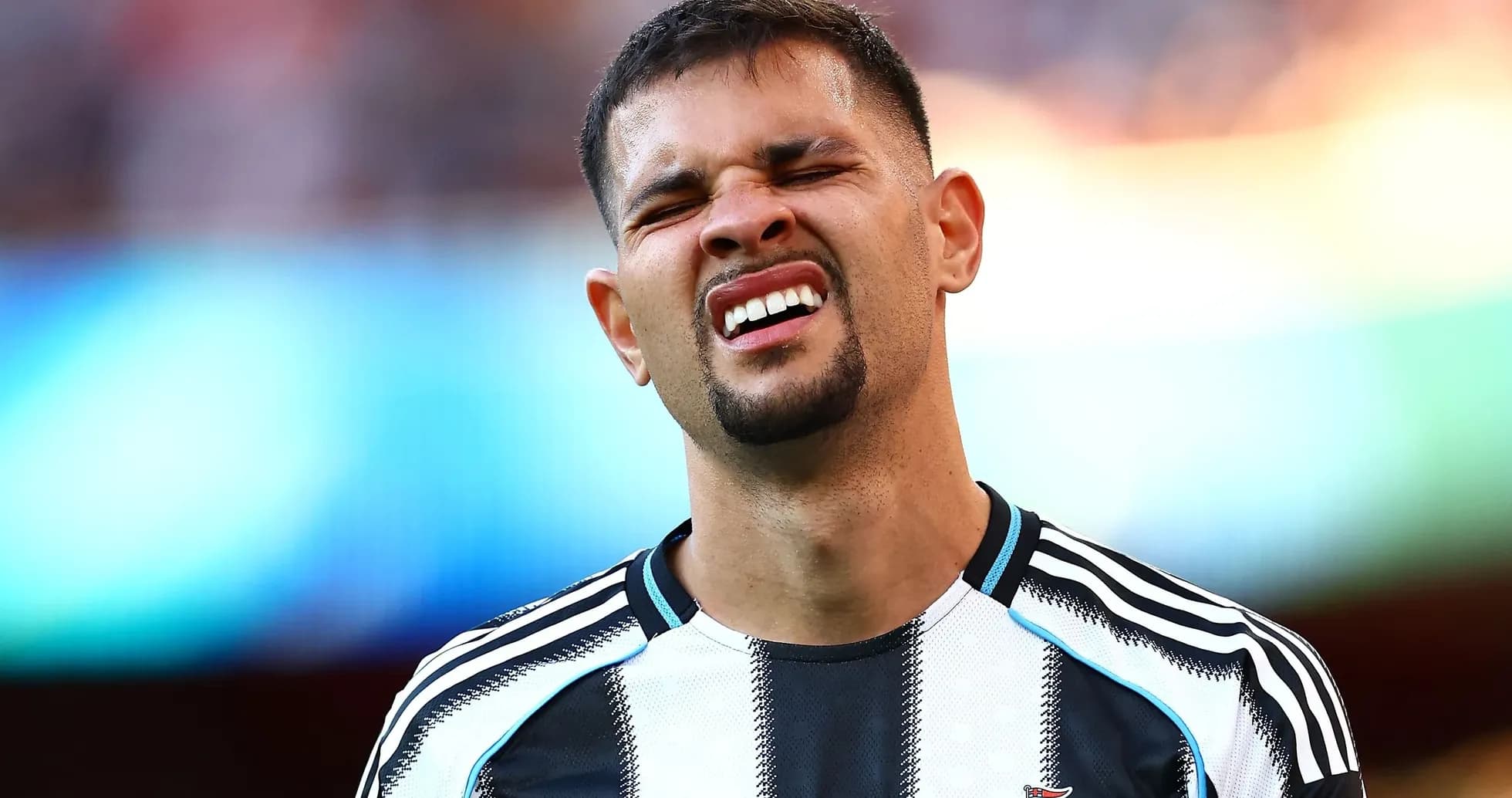 Player grimacing during a football match Player grimacing during a football match