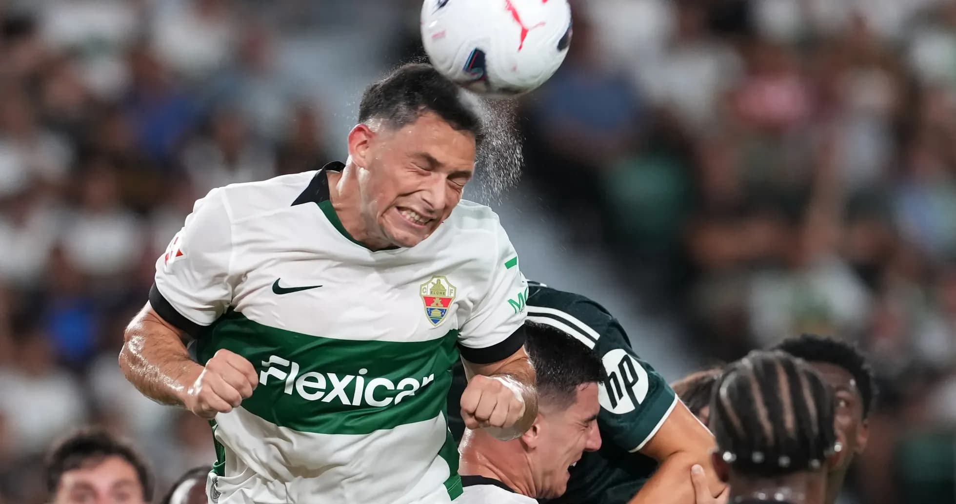 Elche player heading the ball in match Elche player heading the ball in match