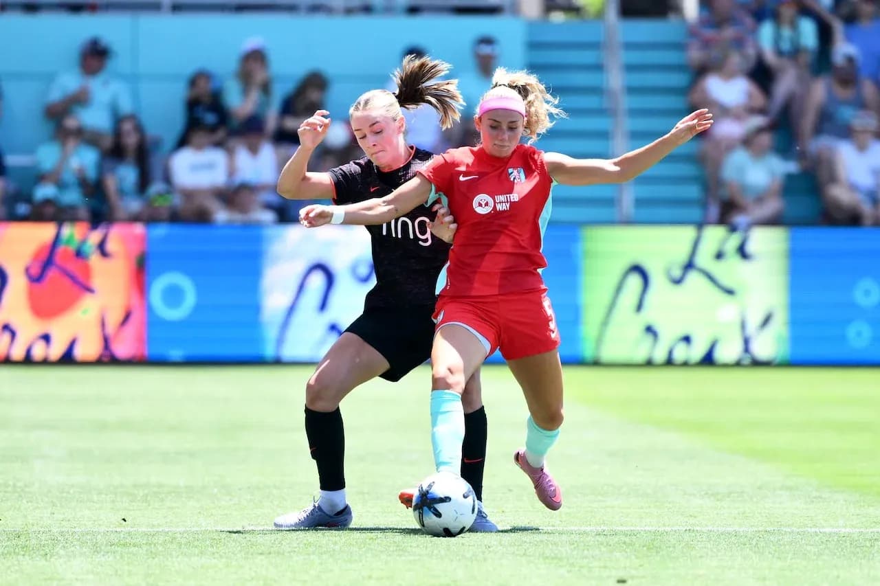 Two players competing for the ball in NWSL match Two players competing for the ball in NWSL match