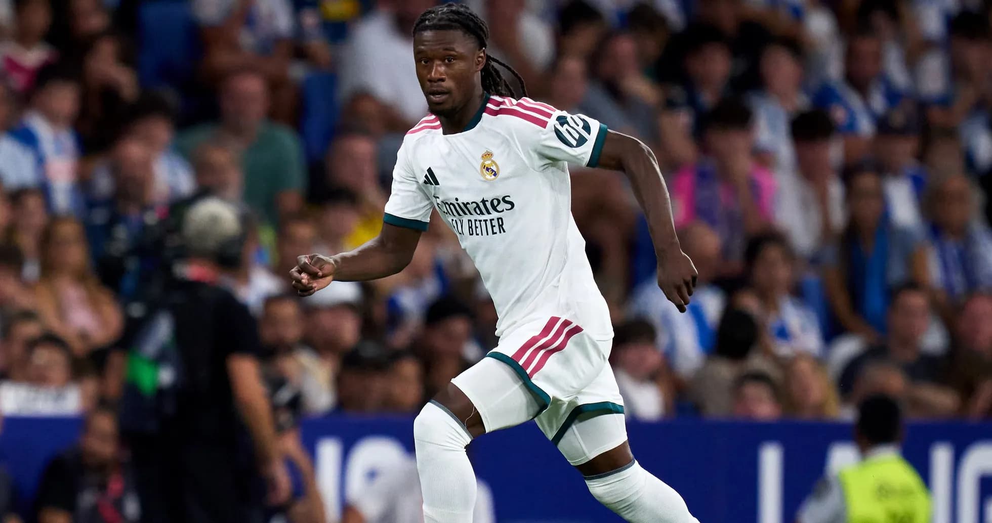 Player in Real Madrid kit running on the field Player in Real Madrid kit running on the field