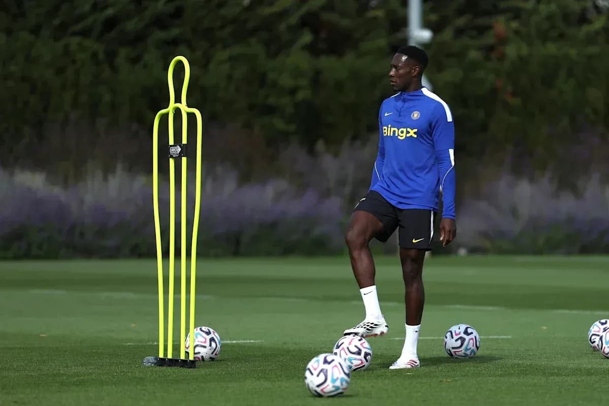 Player practicing with training cones and footballs Player practicing with training cones and footballs