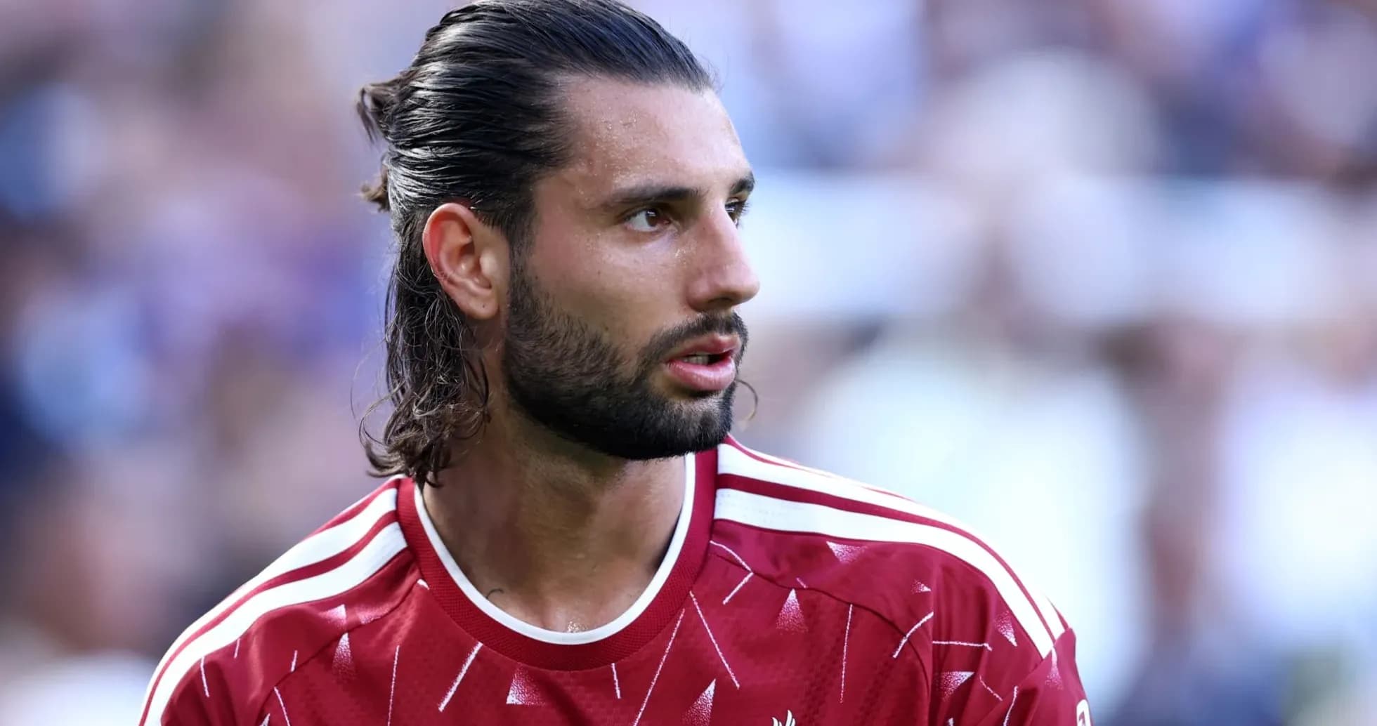 Football player wearing Liverpool jersey during match Football player wearing Liverpool jersey during match