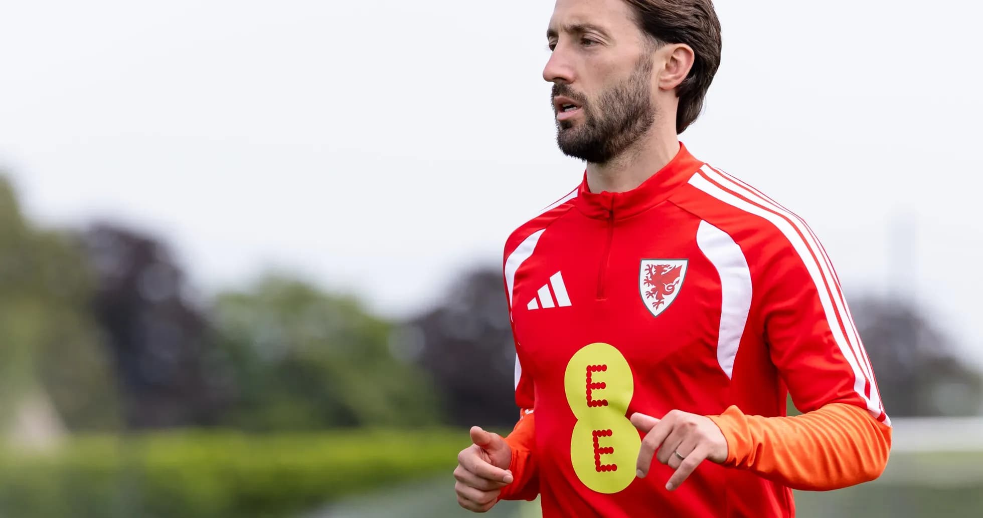 Player jogging in red training kit during practice Player jogging in red training kit during practice