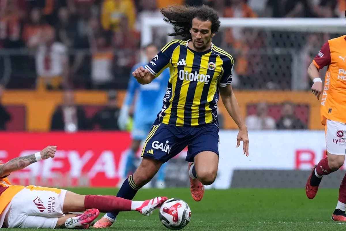 Fenerbahçe player dribbling past opposing player on pitch Fenerbahçe player dribbling past opposing player on pitch