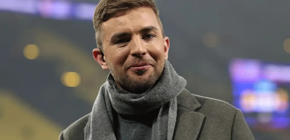 Person wearing a scarf and coat, smiling Person wearing a scarf and coat, smiling