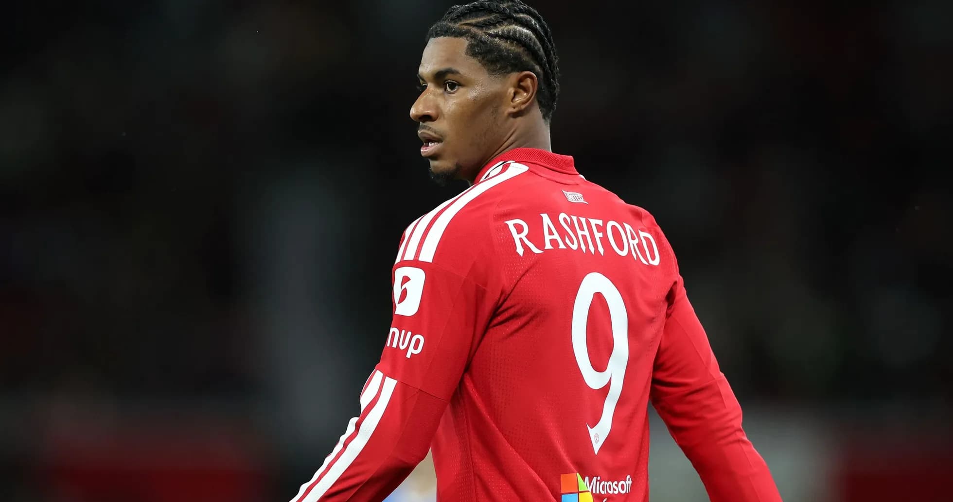 Player in red jersey with 'RASHFORD' on back Player in red jersey with 'RASHFORD' on back