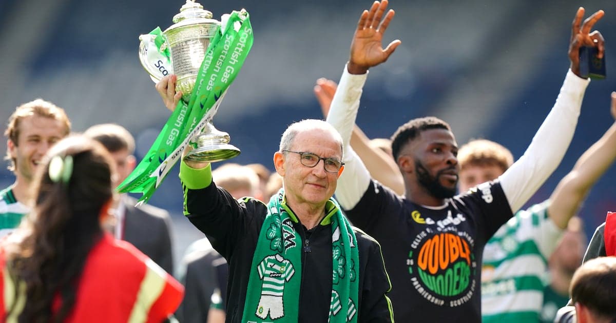 Celtic manager holding trophy with celebrating players Celtic manager holding trophy with celebrating players