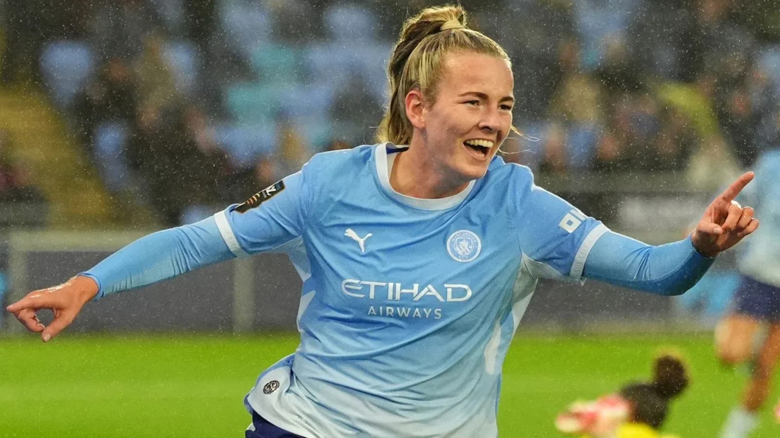 Player celebrating after scoring a goal for Manchester City Player celebrating after scoring a goal for Manchester City