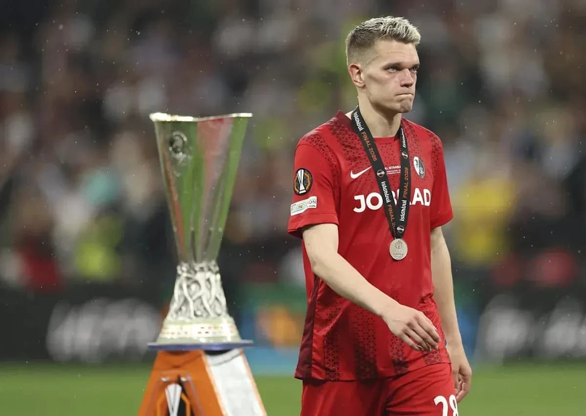 Player in red jersey walking past trophy after match Player in red jersey walking past trophy after match